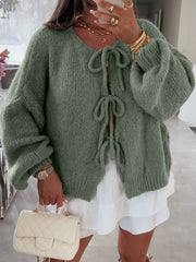 Moss green knit cardigan with balloon sleeves and tie front closure.