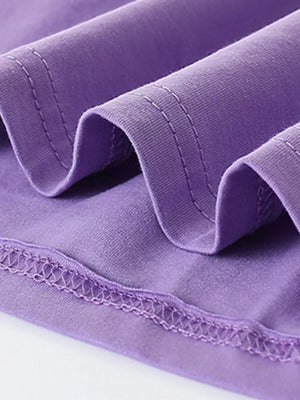 Purple cotton blend toddler dress detail showing stitched seams and fabric texture.