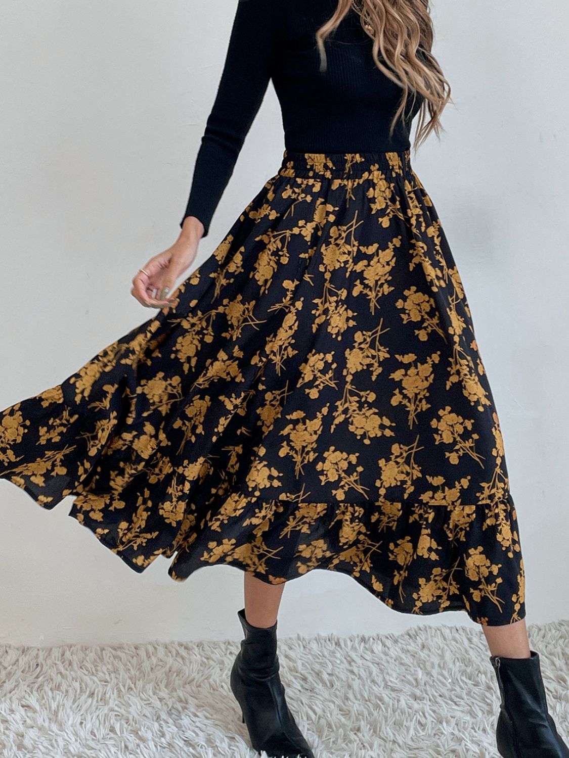 Tiered midi skirt with a black and yellow floral print and ruffled hem.