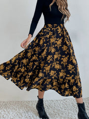 Tiered midi skirt with a black and yellow floral print and ruffled hem.