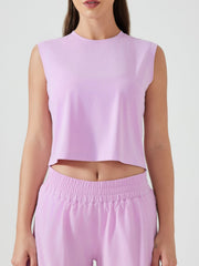 Sculpted crop active muscle tee in pink purple, sleeveless with crew neck.