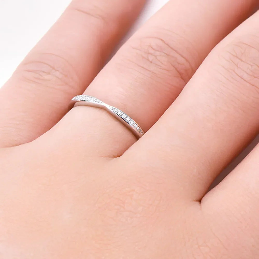 Silver moissanite chevron contour band ring with pavé stones.