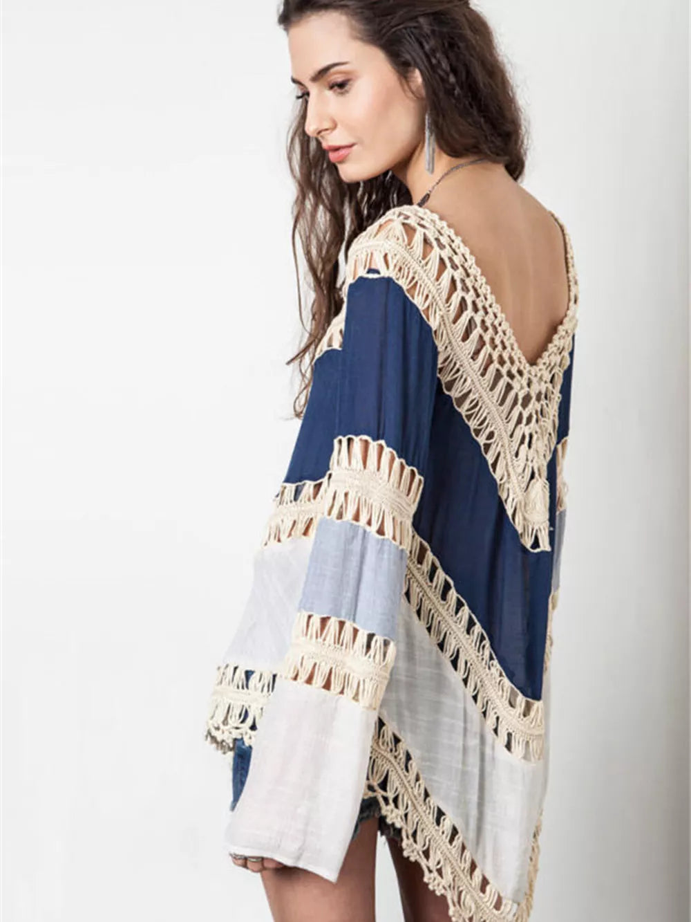 Blue and white long sleeve cardigan with crochet trim and cutout details.