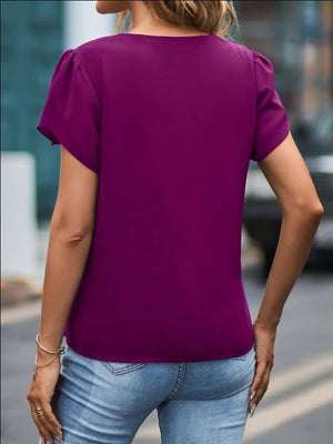 Red-Violet lace trim flutter sleeve blouse with a round neckline, styled with jeans.