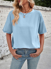 Light blue cotton oversized tee with seam details and rolled sleeves.