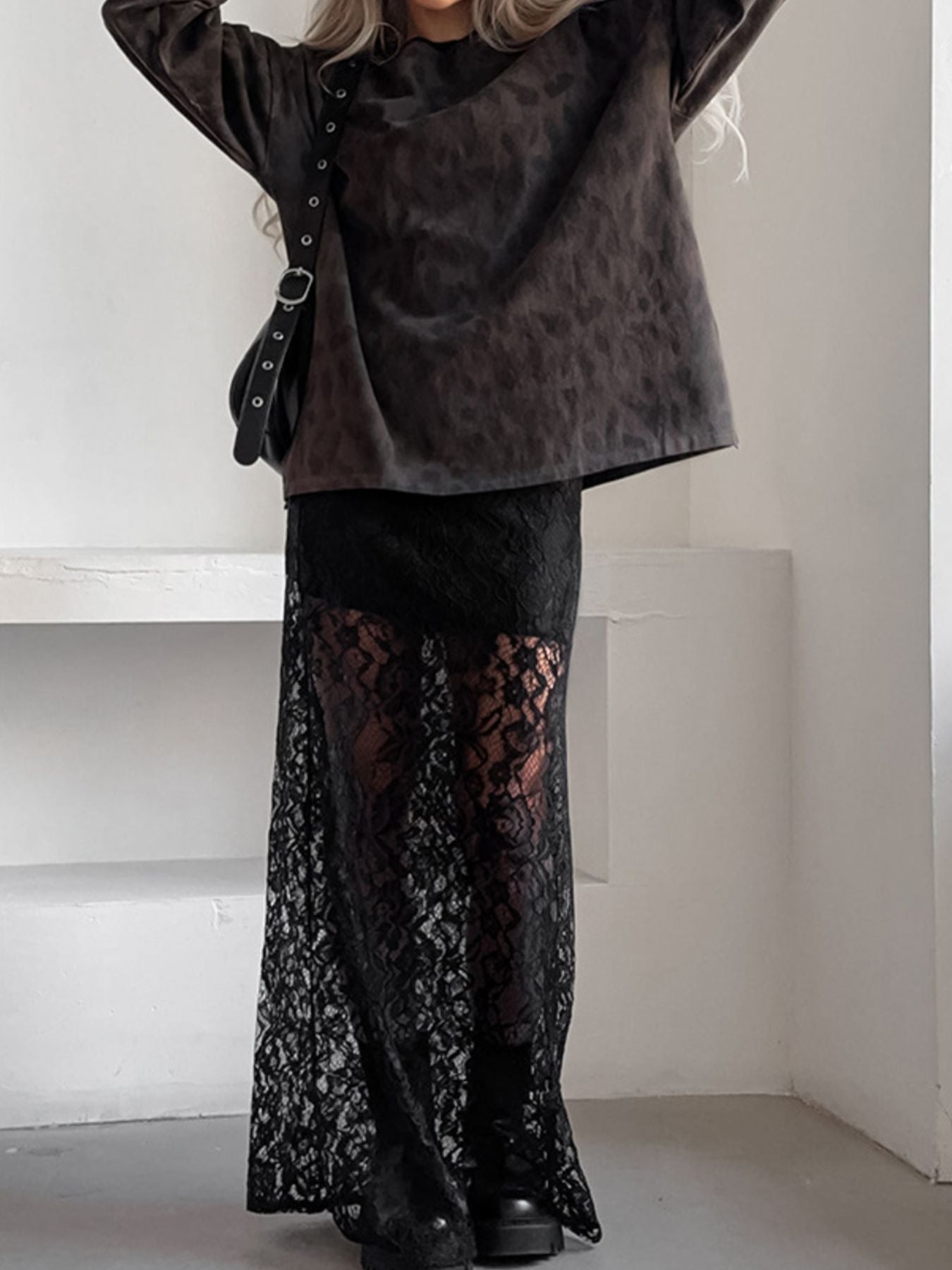 Black lace maxi skirt with sheer detail and a floral pattern.