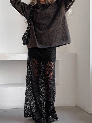 Black lace maxi skirt with sheer detail and a floral pattern.
