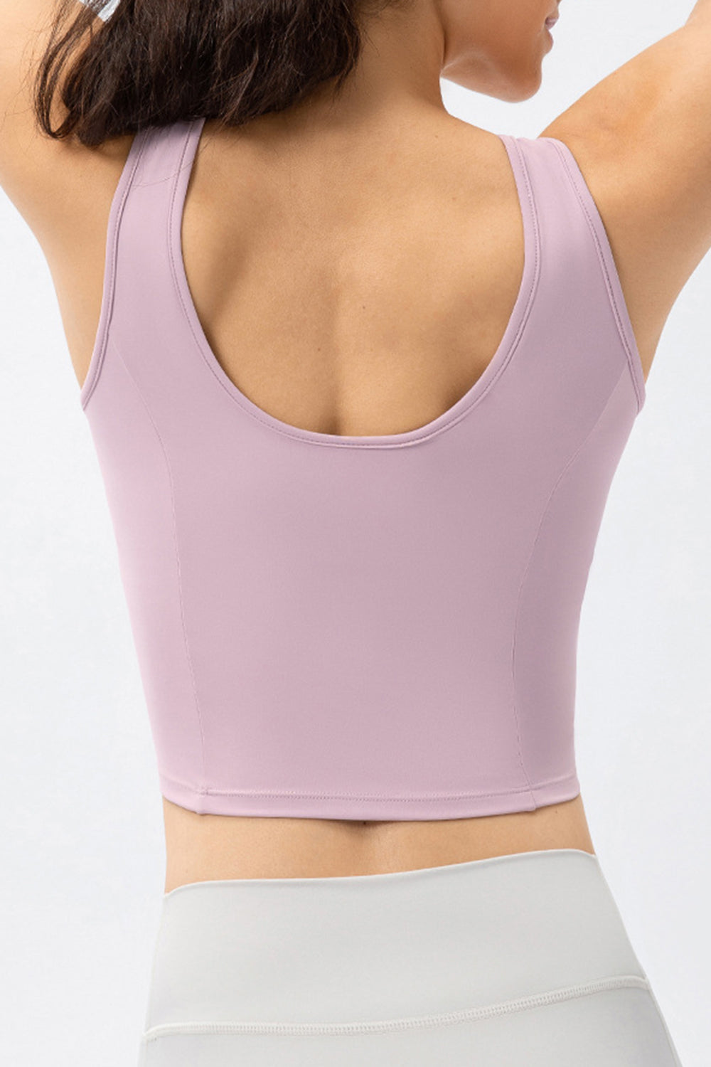 Lilac active crop top with scoop neck and sculpted seams, shown from the back.