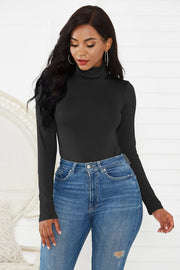 Black turtleneck thong bodysuit with long sleeves, styled with high-waisted jeans.