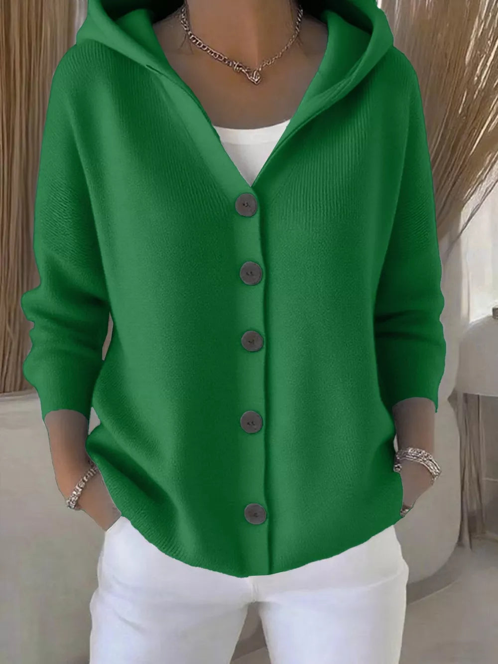Green hooded button-front knit cardigan with a V-neck and ribbed texture.
