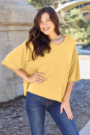 Yellow boxy dolman crop t-shirt with relaxed fit and short sleeves.