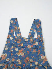 Floral denim overalls with adjustable straps and button details.