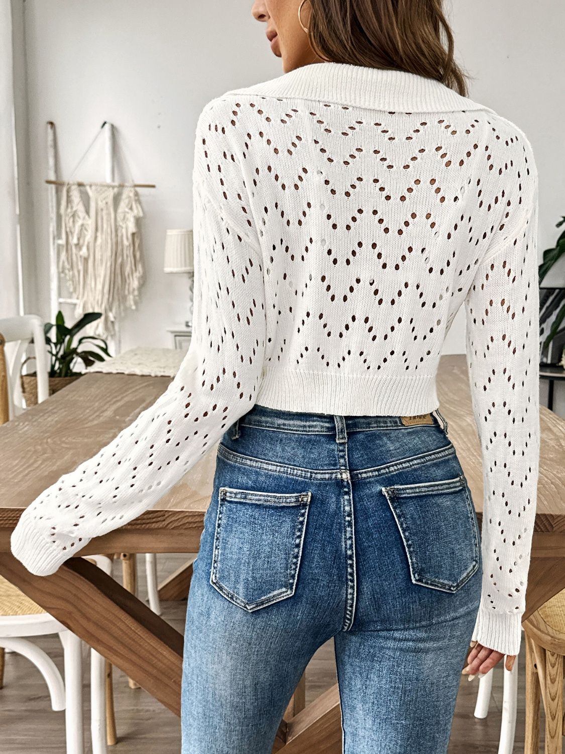 White cropped pointelle knit polo top with chevron pattern and long sleeves.