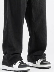 Black corduroy wide-leg sweatpants with a vertical stripe texture.