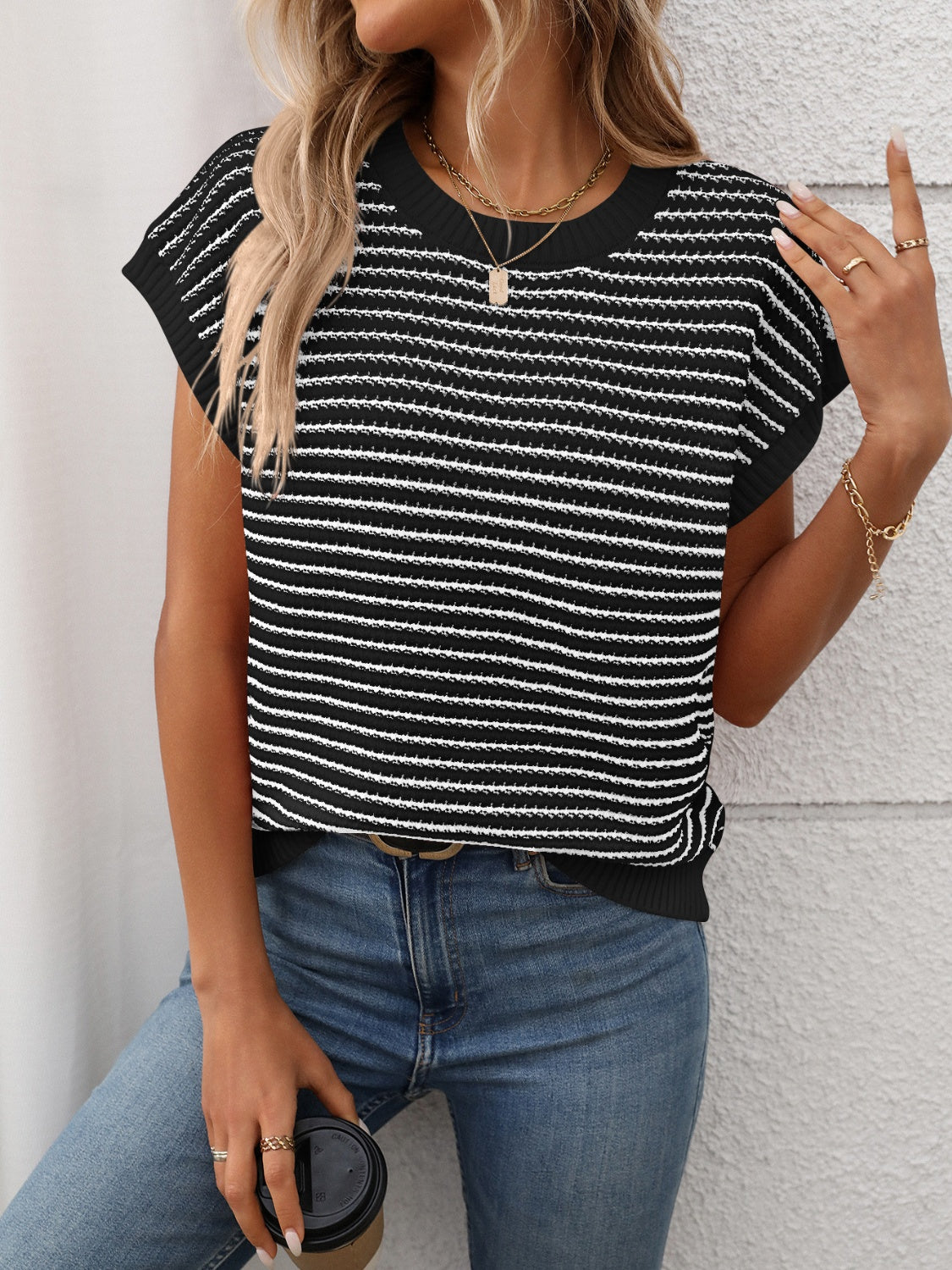 Black and white horizontal stripe knit shell top with crew neck and cap sleeves.