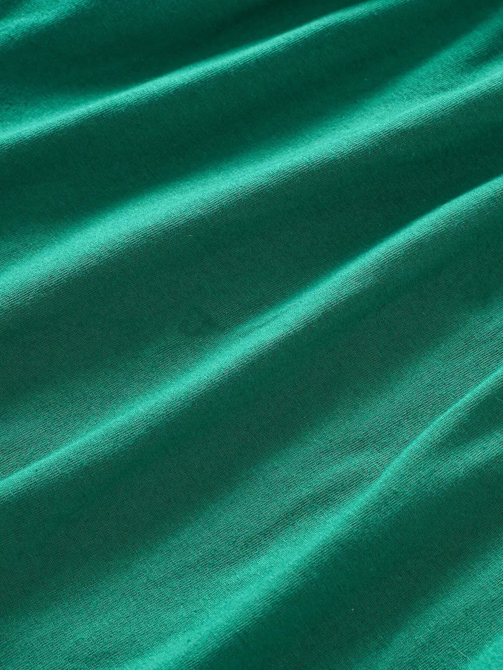 Green A-line baby dress in cotton blend fabric with subtle texture.