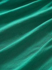 Green A-line baby dress in cotton blend fabric with subtle texture.