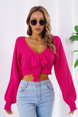 Tie-front balloon sleeve crop knit sweater in Deep Rose acrylic with V-neck.