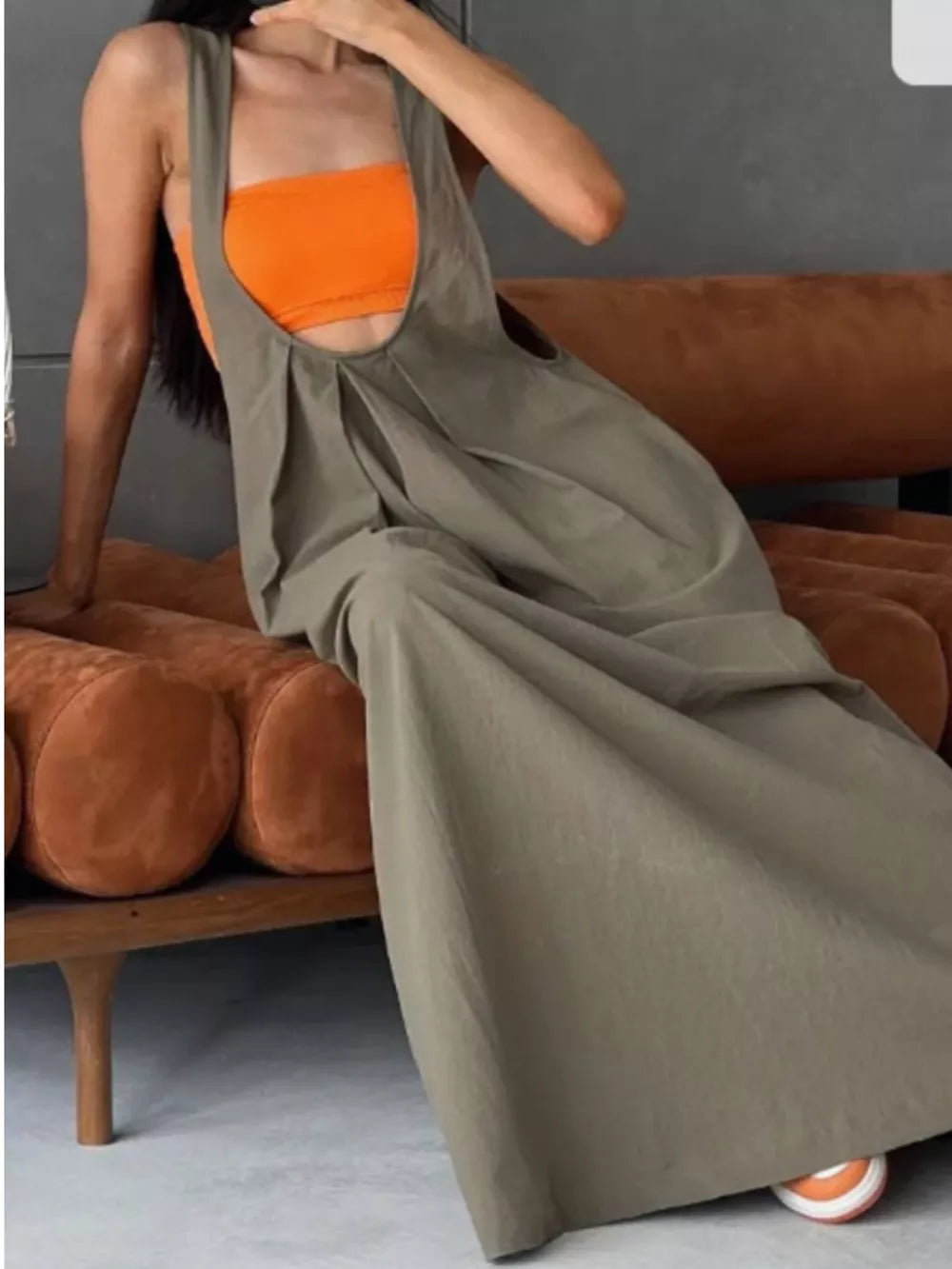 Army green pleated overall dress with a wide leg and pockets, styled with an orange bandeau top.