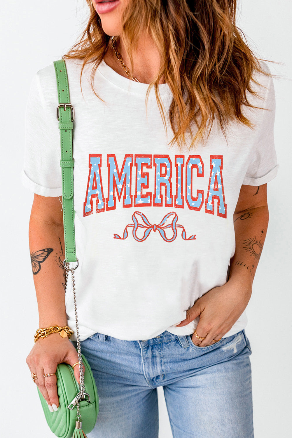 White graphic tee with Americana text and bow detail