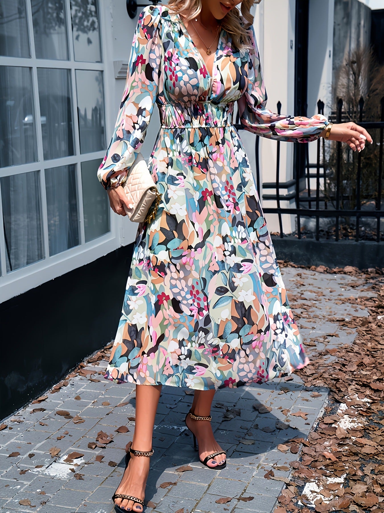 Floral print midi dress with V-neck, long sleeves, and smocked waist.
