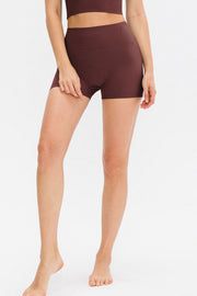 Burgundy ribbed sculpting active shorts with a high waist and seamless design.