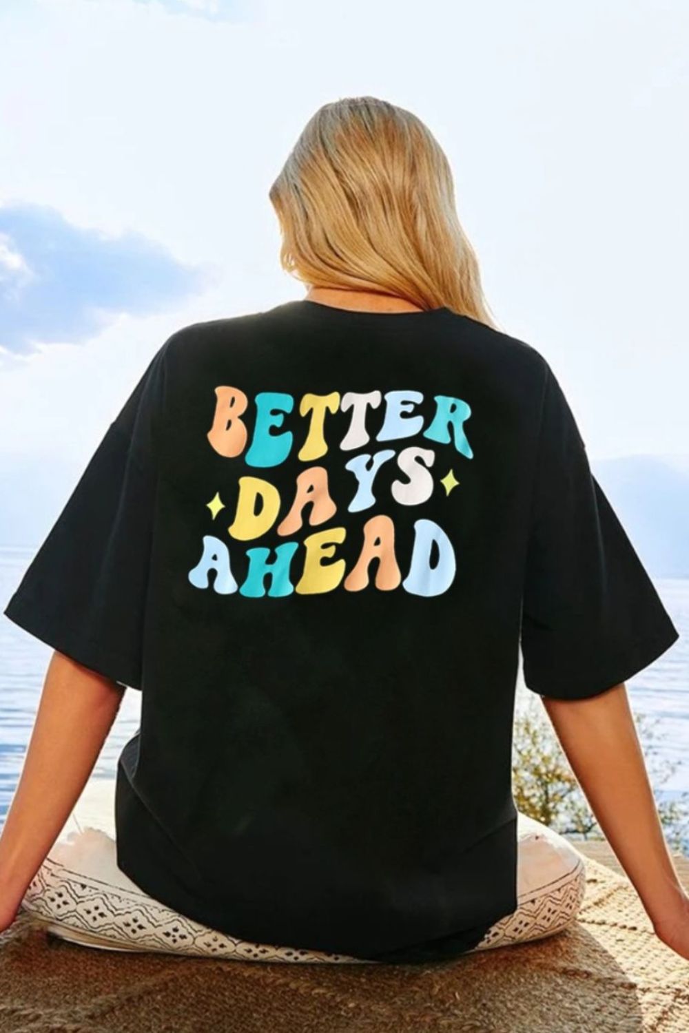 Black oversized graphic tee with retro "Better Days Ahead" text in colorful wavy font.