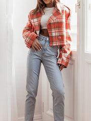 Boxy plaid cropped blazer in orange with button detail, worn with light wash jeans.