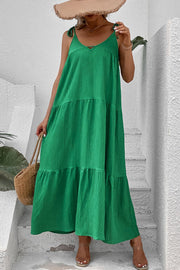 Green tiered maxi dress with tie straps and textured fabric.