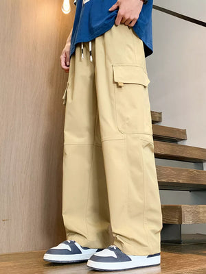 Khaki oversized cargo pants with adjustable drawstring and large side pockets.