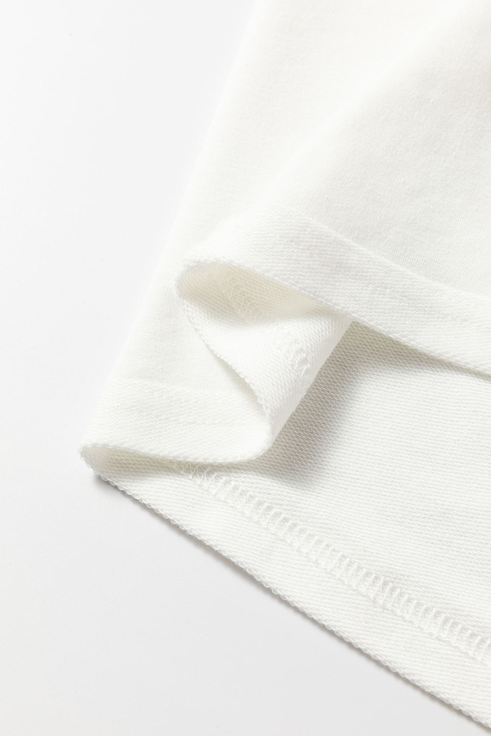 White sweatshirt detail showing fabric texture and stitching