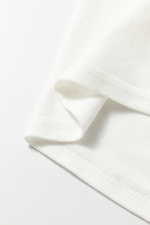 White sweatshirt detail showing fabric texture and stitching