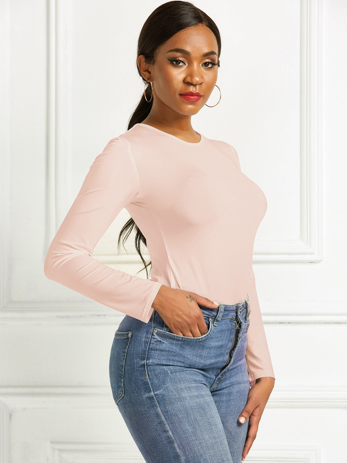 Apricot ribbed long sleeve bodysuit with crew neck, body-hugging fit.
