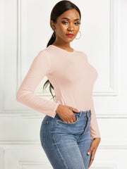 Apricot ribbed long sleeve bodysuit with crew neck, body-hugging fit.