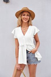 White flutter sleeve peplum blouse with ruffled hem and button front.