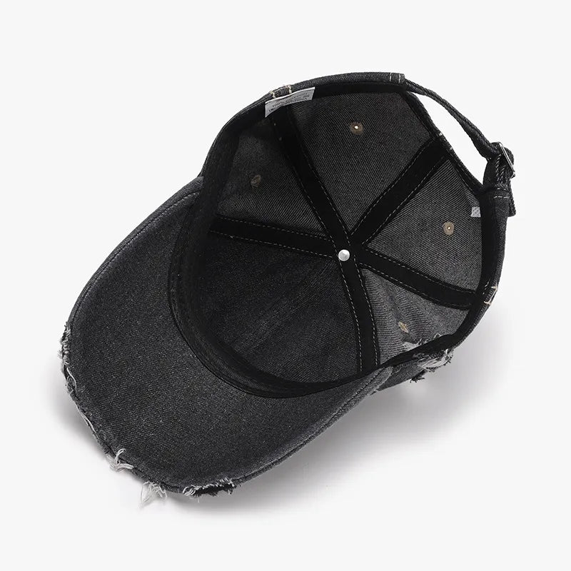 Dark ripped denim baseball cap with distressed brim and adjustable strap.