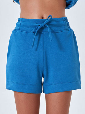 Sky blue drawstring pocket shorts with elastic waistband and cuffed hem.
