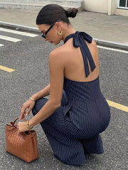 Navy pinstripe halter jumpsuit with tie back and pockets, cotton blend.