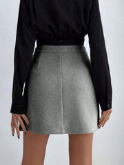 Gray asymmetric mini skirt with button detail, styled with a black top.