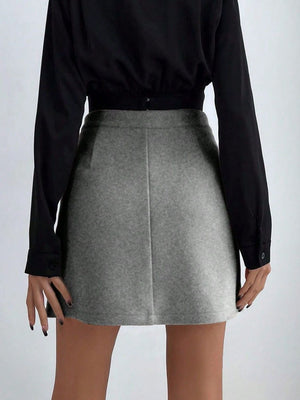 Gray asymmetric mini skirt with button detail, styled with a black top.