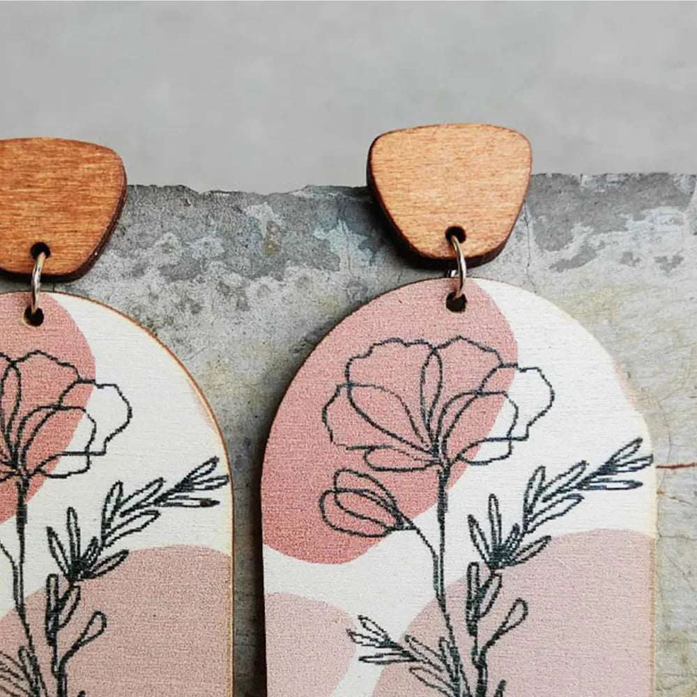 Botanical arch wood earrings in dusty pink with floral line art and boho abstract shapes.