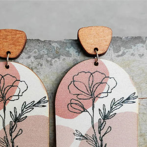 Botanical arch wood earrings in dusty pink with floral line art and boho abstract shapes.