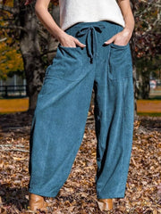 Blue corduroy wide-leg pants with pockets and drawstring waist.