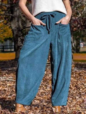 Blue corduroy wide-leg pants with pockets and drawstring waist.