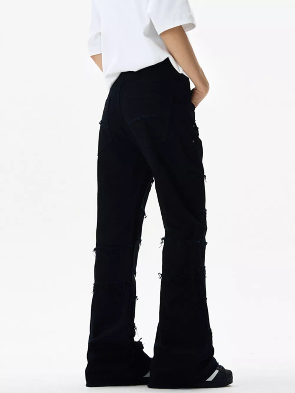 Black stretch flare jeans with frayed hem details and distressed accents.