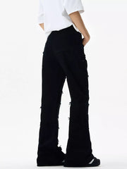 Black stretch flare jeans with frayed hem details and distressed accents.