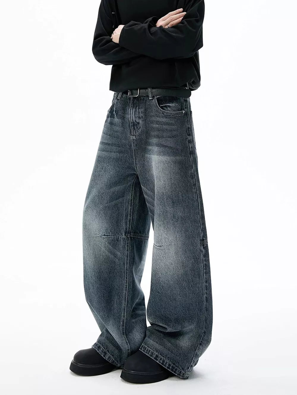 Belted dark-wash wide-leg jeans with unique paneled design and a relaxed fit.