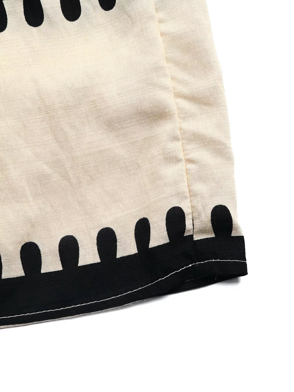 Bohemian maxi dress detail with black graphic print trim on cream fabric