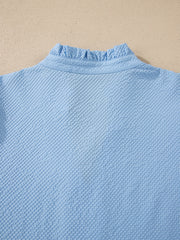Light blue seersucker blouse with ruffled collar detail
