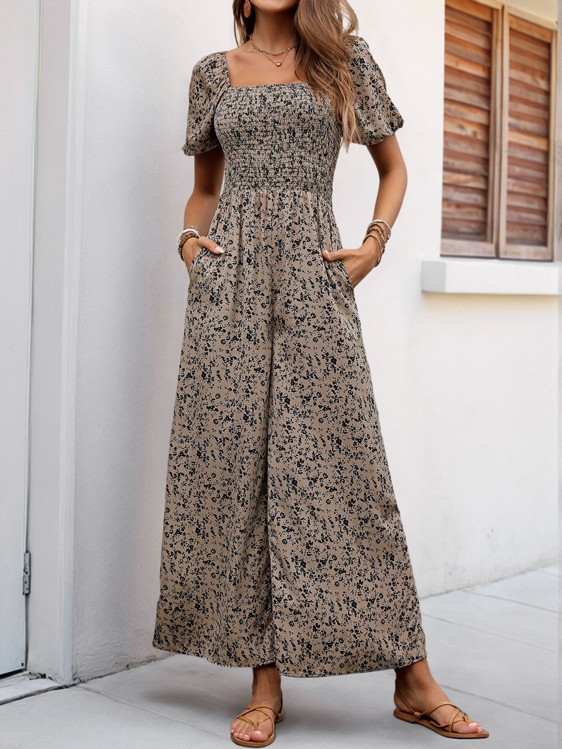 Smocked bodice floral palazzo jumpsuit in taupe with short puff sleeves and square neckline.